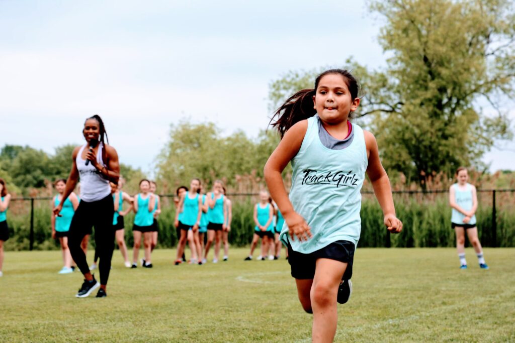 Little girl running in a TrackGirlz shirt