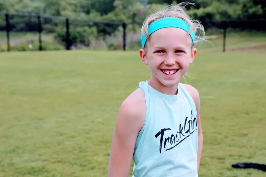 girl is smiling while wearing a TrackGirlz shirt