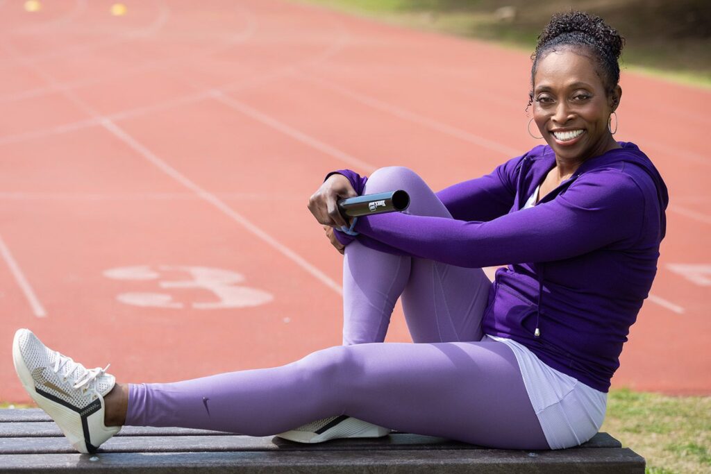 Gail Devers sits at the track, holiday a baton