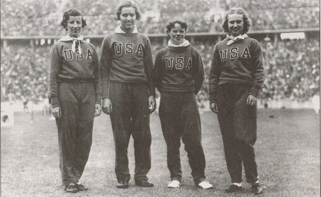Team USA. Four women stand in their kit.