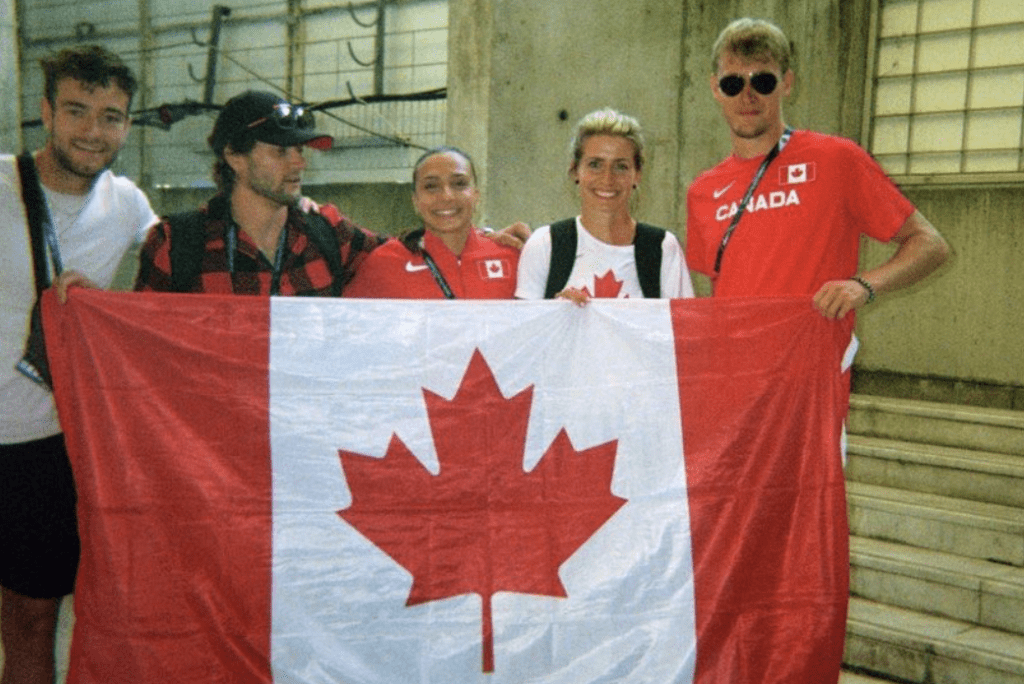 Papaconstantinou and Athletics Canada teammates holding the Canadian flag