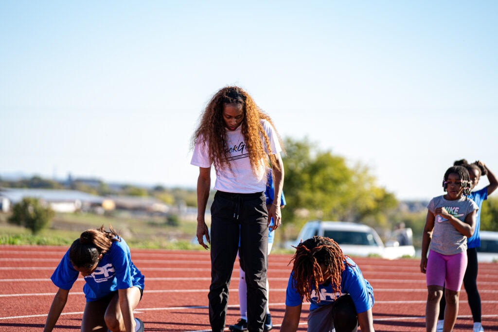 Mechelle Lewis Freeman coaches two athletes through starts