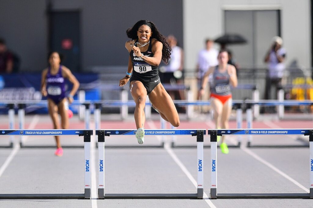 Glenn runs over a hurdle at the NCAA Championships 