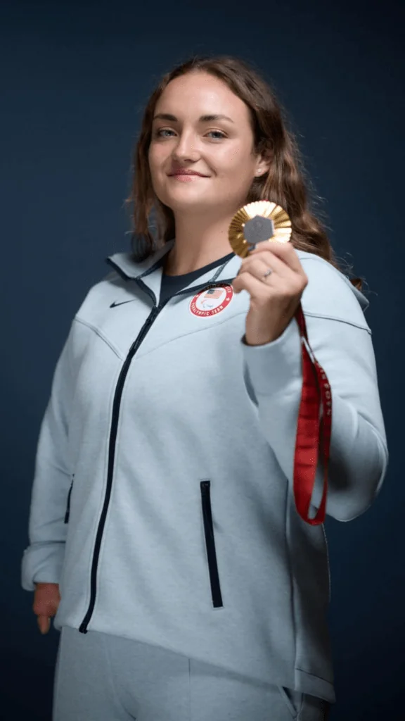 Athlete holds their Paralympic medal 