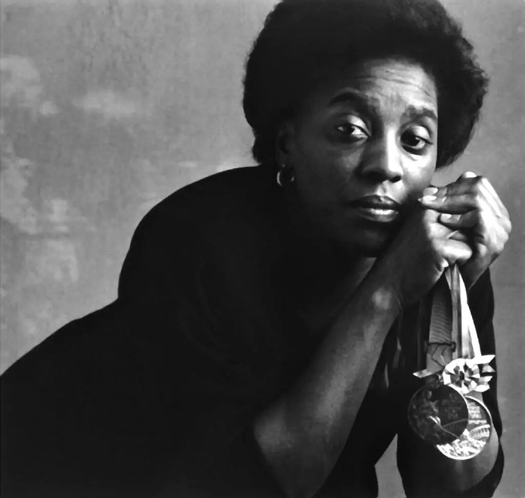 Tyus holding her medals