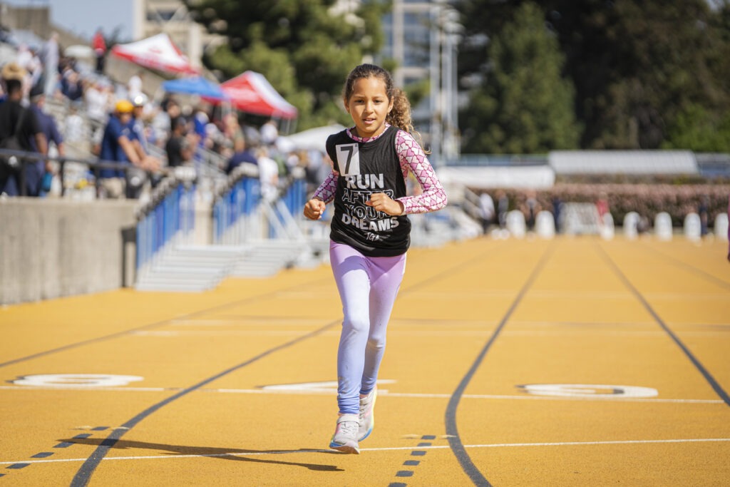 Girl runs the 200m in her TrackGirlz kit